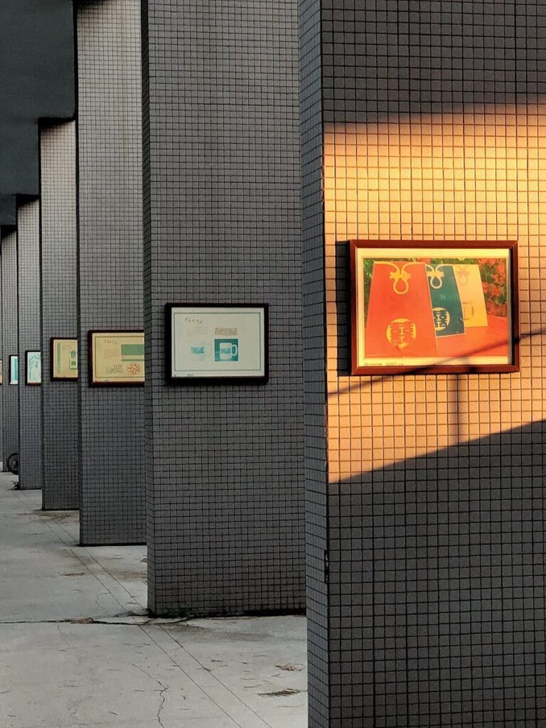 Frames hanging in a modern minimalist art exhibition with soft lighting.